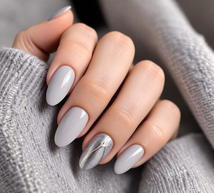 Soft grey almond nails with a silver marble accent